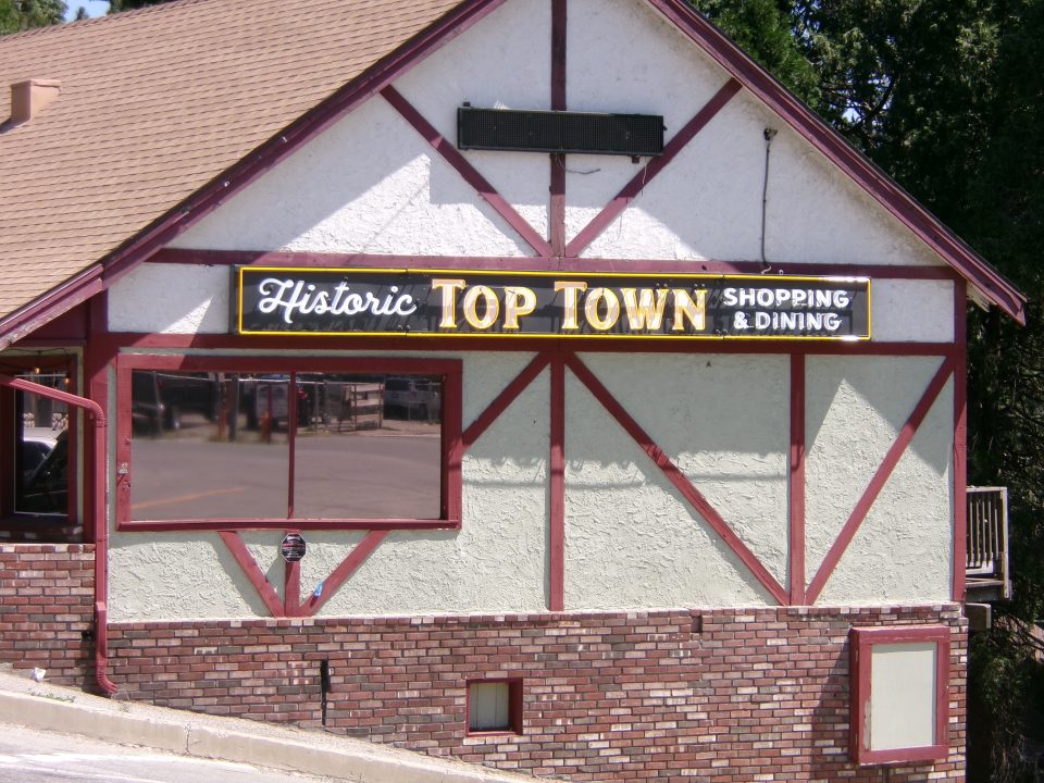 The new neon sign is placed on the side of the Crest Forest Senior Citizens Club furniture thrift store in Top Town Crestline, welcoming residents and visitors to town.