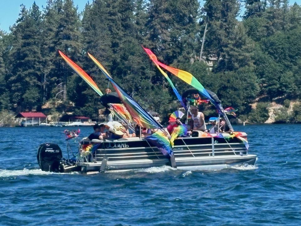 Adrianne, Lisa, Julia, Melissa and Adrianna from Glendora and Orange County enjoyed last year’s Brewfest at Tavern Bay Beach Club so much they couldn’t resist attending this year’s event. (Photos by Douglas W. Motley) Boat decorated with rainbow flags on a lake
