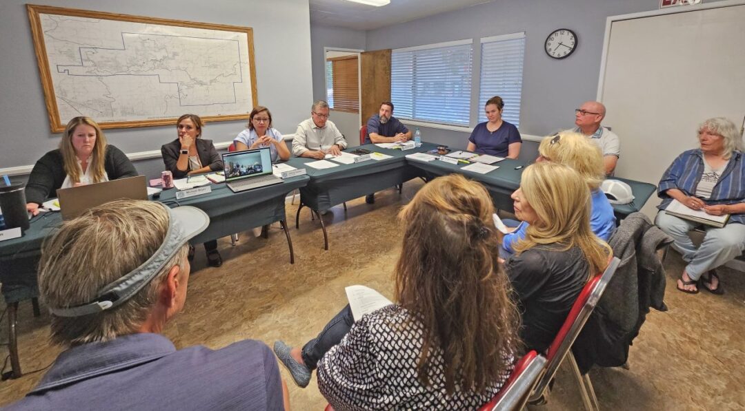 Group meeting with people around a conference table.