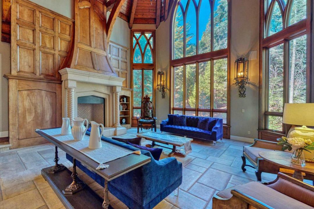 The living room features replicas of the Yale University chapel windows, which afford views to the forest.