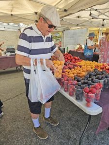 Wendell Wilson of the Mountain Homeless Coalition chooses just the right container of apricots.