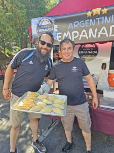 Alex Vallejos (left), the organizer of the Twin Peaks market at the empanadas booth.