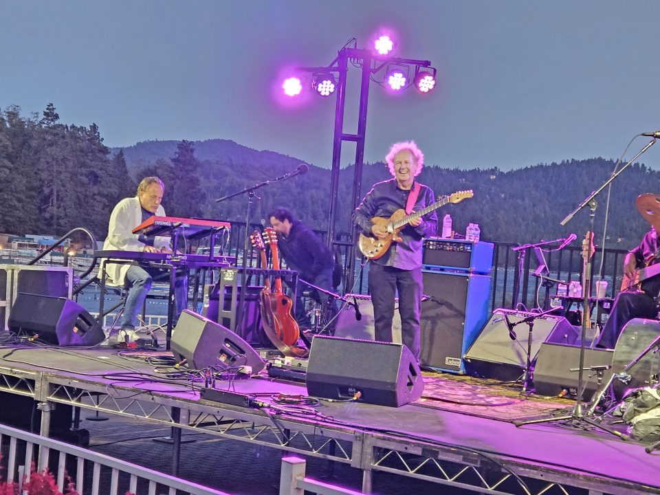 Musicians performing outdoors at a scenic venue.