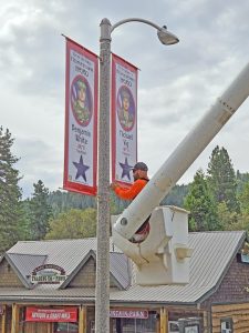 Josh Snyder puts the finishing touches on Michael Vig’s banner. It hangs on the same pole with a banner for his brother-in-law Benjamin White.