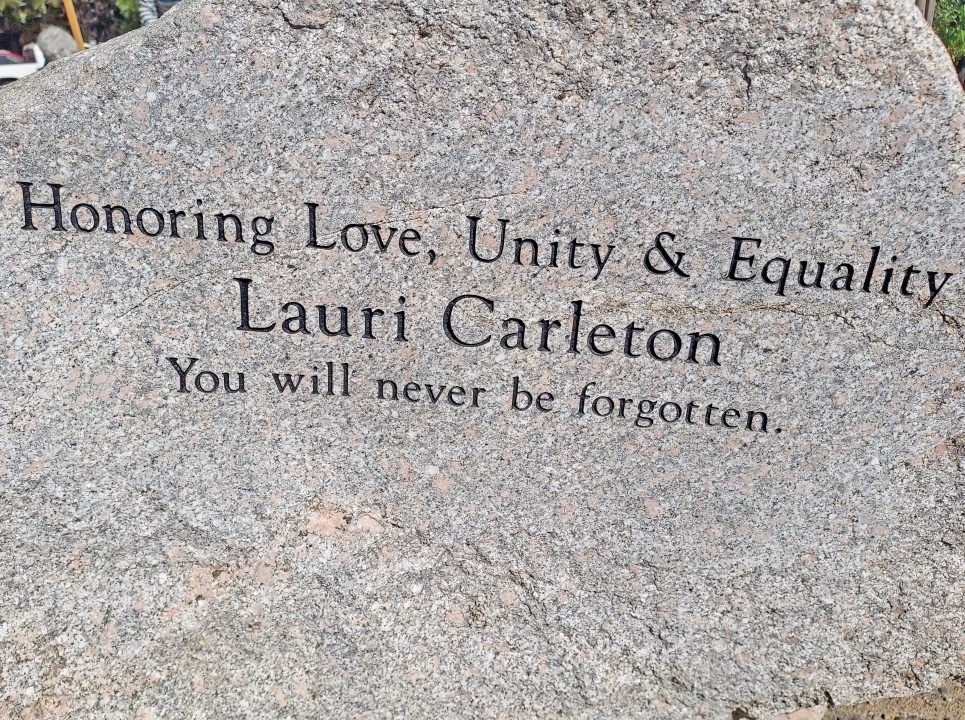 Memorial plaque honoring love, unity, equality.