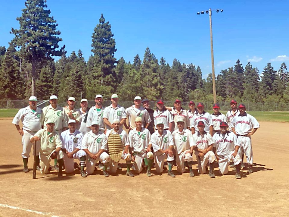 Vintage baseball teams posing on field