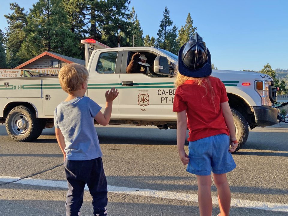 Smokey Bear waves at parade spectators.