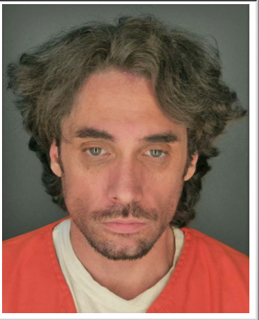 Mugshot of a man with long hair and beard.