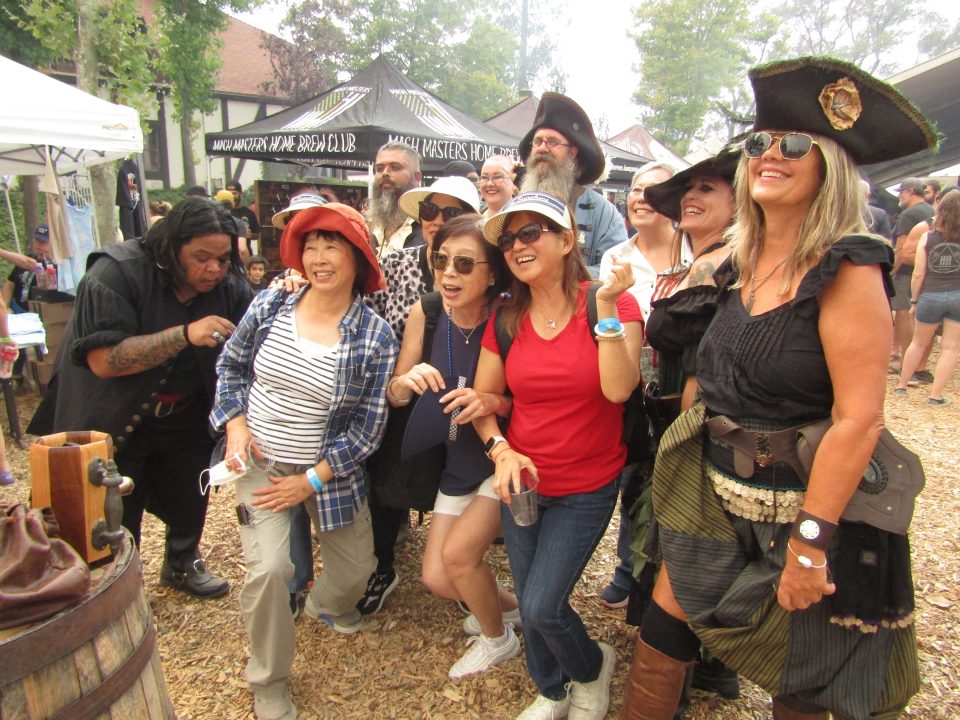 Adrianne, Lisa, Julia, Melissa and Adrianna from Glendora and Orange County enjoyed last year’s Brewfest at Tavern Bay Beach Club so much they couldn’t resist attending this year’s event. (Photos by Douglas W. Motley) Group posing in pirate costumes at outdoor event