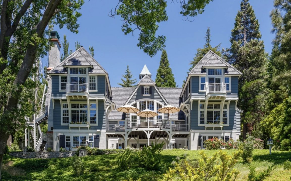 Charming Victorian house surrounded by trees.