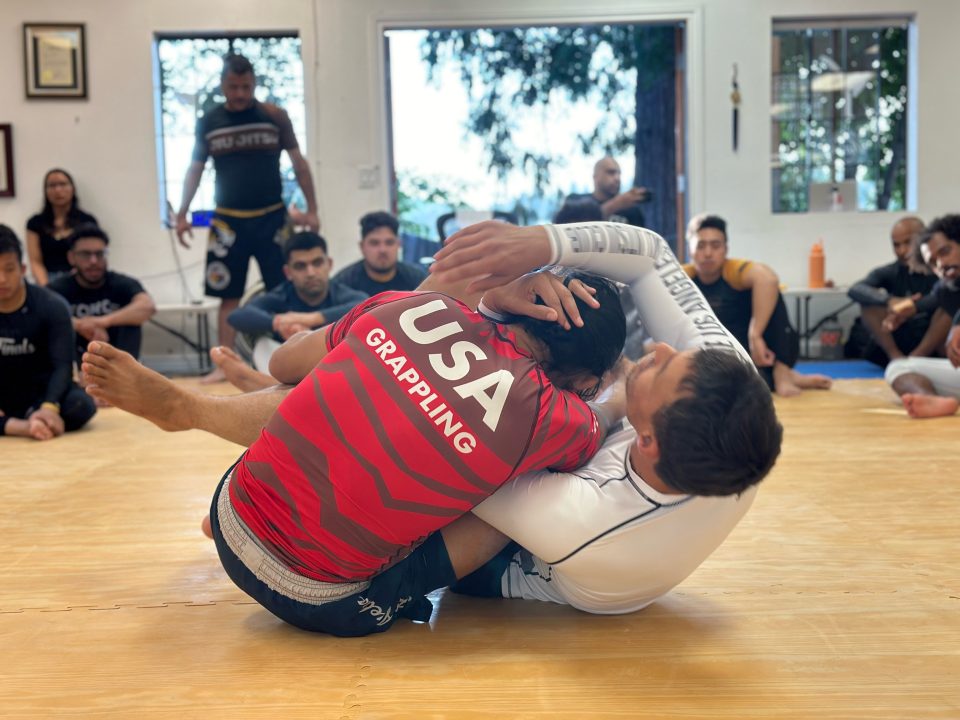 Adrianne, Lisa, Julia, Melissa and Adrianna from Glendora and Orange County enjoyed last year’s Brewfest at Tavern Bay Beach Club so much they couldn’t resist attending this year’s event. (Photos by Douglas W. Motley) Two athletes practicing grappling technique on mat.
