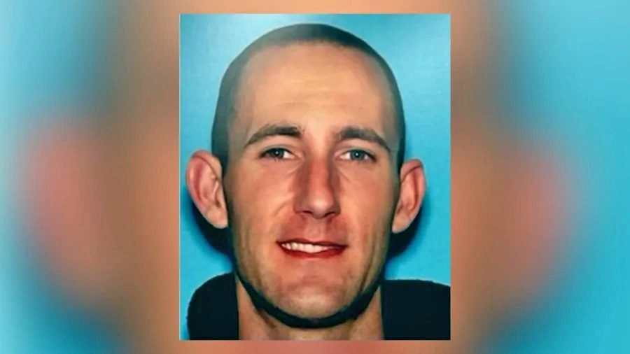Close-up of unidentified person against blue background.