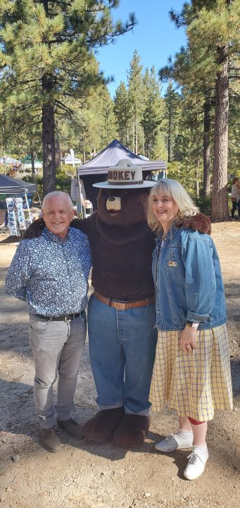 Smokey Bear stands on the foot of assemblyman Tom Lackey last year.