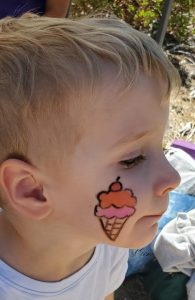 This local child had his face painted in Camp Cheekers by Rim Rec volunteers at last year’s Fesetival.