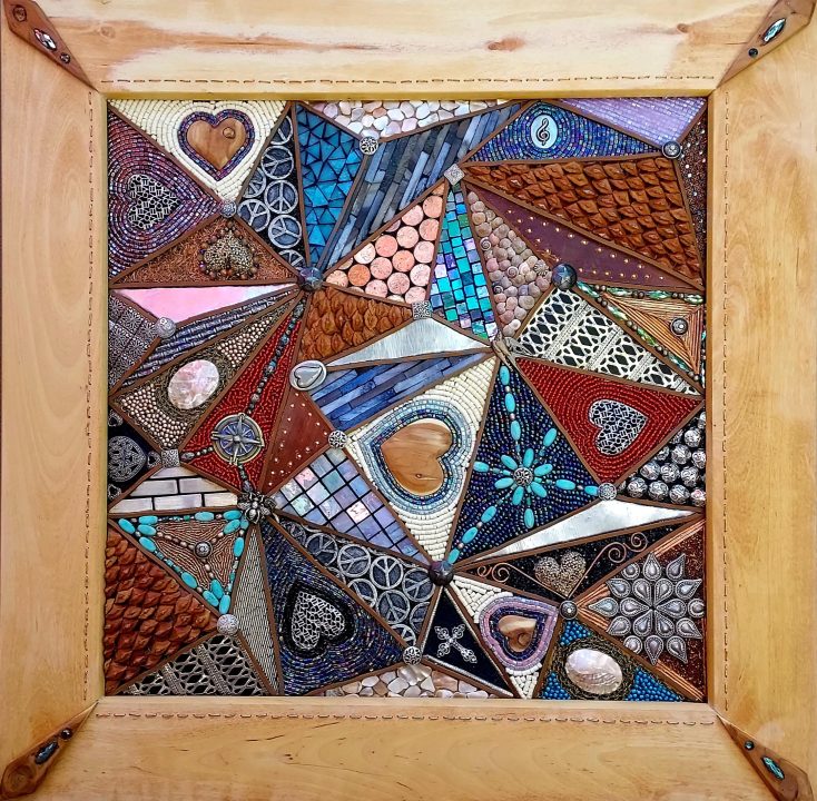 My Heart’s Inspiration by Rena Heagle; 24” x 24” multimedia abstract (wood, silver, ivory, stained glass, copper, leather, turquoise, metal medallions, pinecone petals and glass beads with handmade clay-relief patterns)