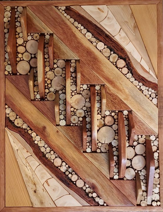 Untitled piece by Rena Heagle; 24” x 18” abstract with Santos mahogany, Douglas fir, pine and tree-branch rounds