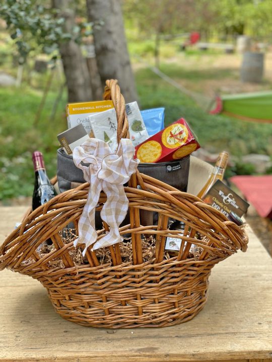 Adrianne, Lisa, Julia, Melissa and Adrianna from Glendora and Orange County enjoyed last year’s Brewfest at Tavern Bay Beach Club so much they couldn’t resist attending this year’s event. (Photos by Douglas W. Motley) Gift basket with wine and gourmet snacks outdoors.