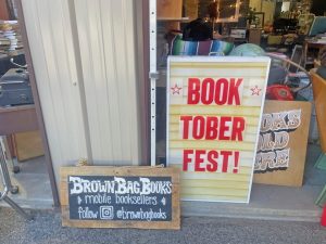 A welcome sign encouraging onlookers to come inside.