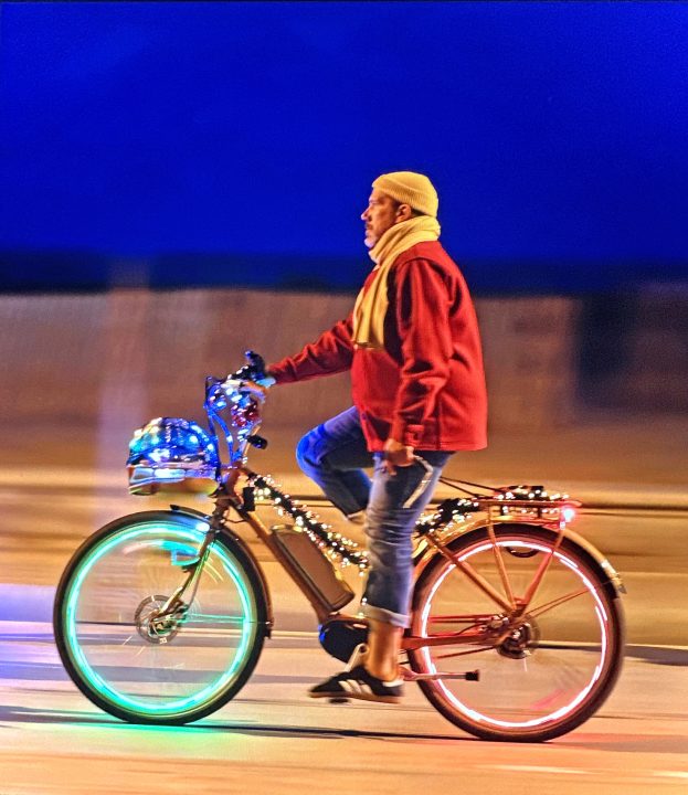 Seizing the moment of photo opportunity, the artist captured a colorful cyclist peddling along a beach sidewalk in Santa Monica.