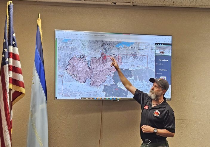 Incident Commander Chris Fogle points to areas on the map where the Line Fire is still active.