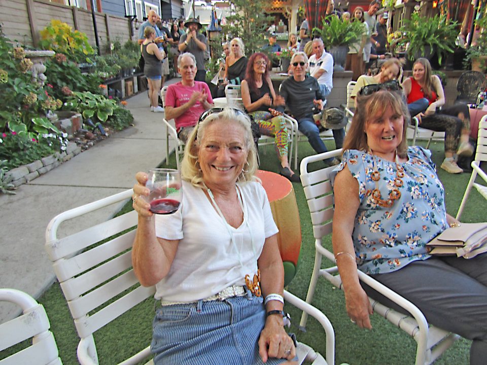Jane Chaname from Banning enjoys some red wine while watching the band play at Bizzyland.