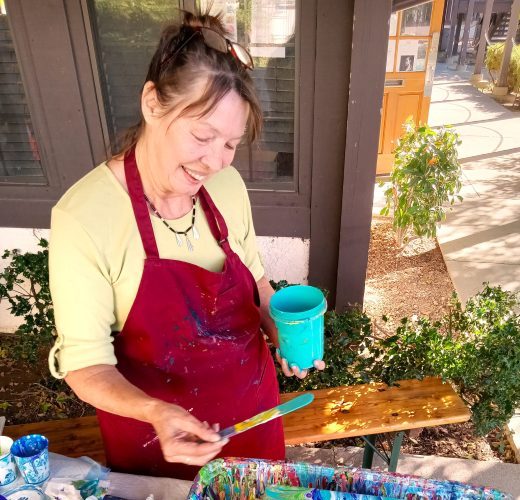 Adrianne, Lisa, Julia, Melissa and Adrianna from Glendora and Orange County enjoyed last year’s Brewfest at Tavern Bay Beach Club so much they couldn’t resist attending this year’s event. (Photos by Douglas W. Motley) Artist painting outdoors with colorful paint.