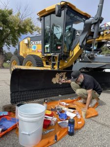 Many parent volunteers like Curtis Mead from the PTA made this event possible. He makes some adjustments to a painting of Cubbie, LAE's school mascot.