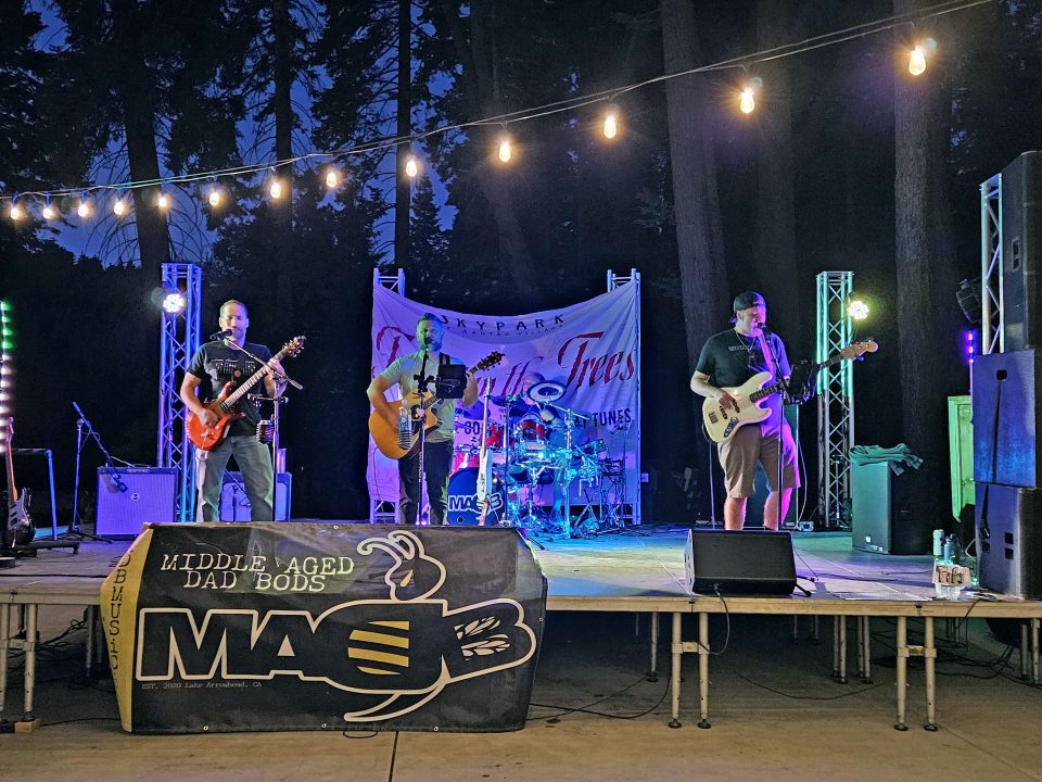 Adrianne, Lisa, Julia, Melissa and Adrianna from Glendora and Orange County enjoyed last year’s Brewfest at Tavern Bay Beach Club so much they couldn’t resist attending this year’s event. (Photos by Douglas W. Motley) Band performing on outdoor stage with instruments.