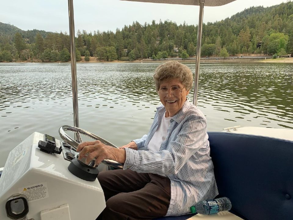Adrianne, Lisa, Julia, Melissa and Adrianna from Glendora and Orange County enjoyed last year’s Brewfest at Tavern Bay Beach Club so much they couldn’t resist attending this year’s event. (Photos by Douglas W. Motley) Woman steering boat on picturesque lake.