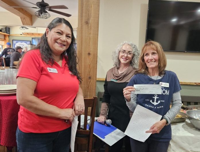 Alma Diaz (left) and Vicki Garner were all smiles after receiving a donation from Jeri Simpson of the Women’s Club of Lake Arrowhead.
