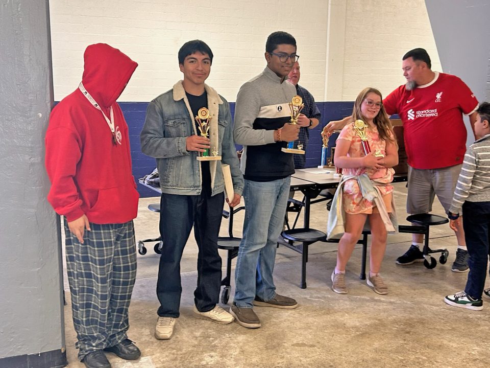 The winners of the high school division. Chess Club President Oscar Ramiez is in the denim jacket. (Photos by Isabella Dino)
