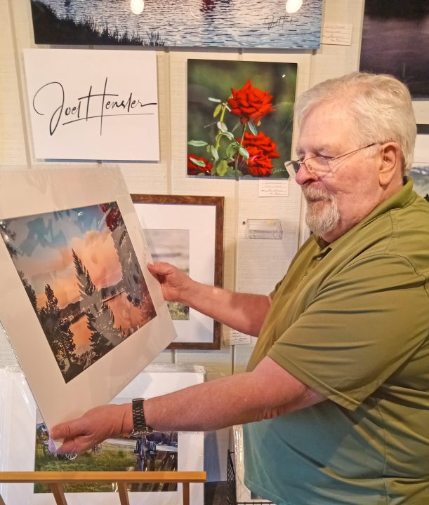 Adrianne, Lisa, Julia, Melissa and Adrianna from Glendora and Orange County enjoyed last year’s Brewfest at Tavern Bay Beach Club so much they couldn’t resist attending this year’s event. (Photos by Douglas W. Motley) Man holding framed landscape artwork in gallery.