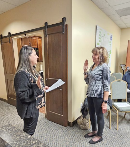 Two women taking an oath in a room.
