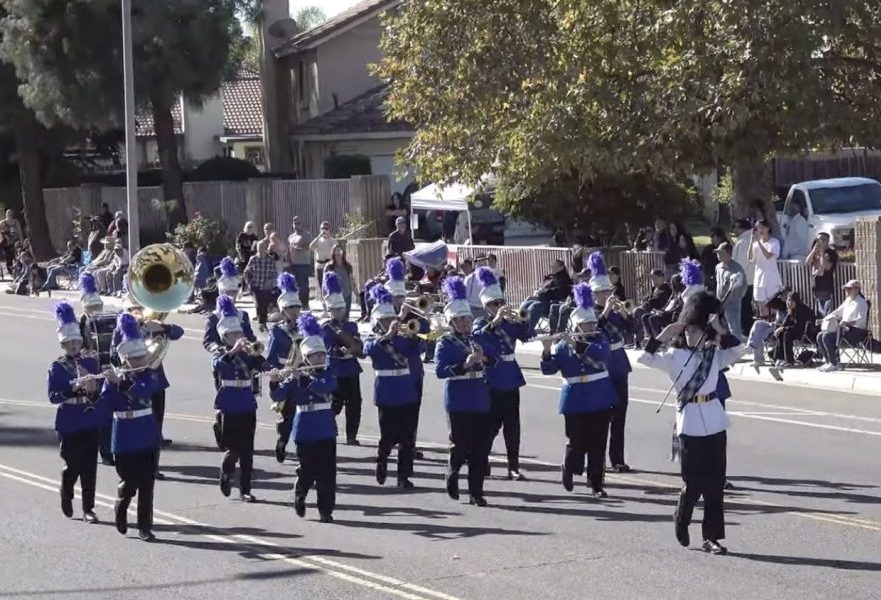 Marching band performing in a street parade.