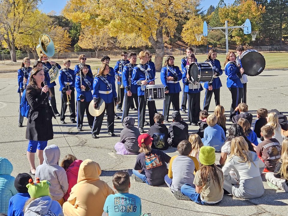 Music Director Kari Stebbing called the percussion line to the front of the band to demonstrate their instruments.