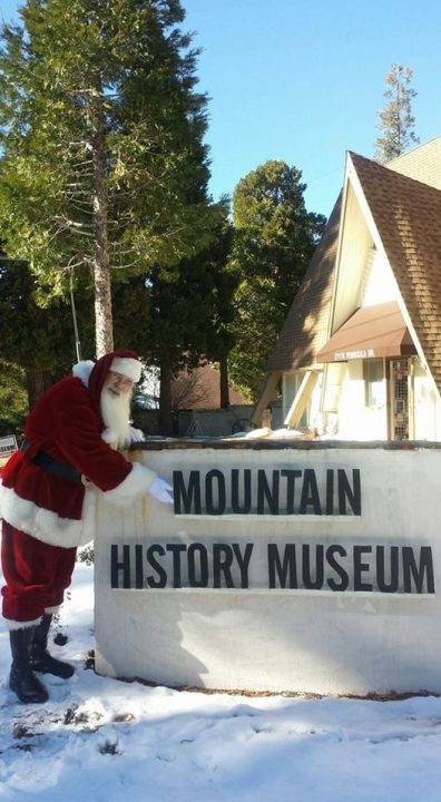 Santa at Mountain History Museum entrance sign.