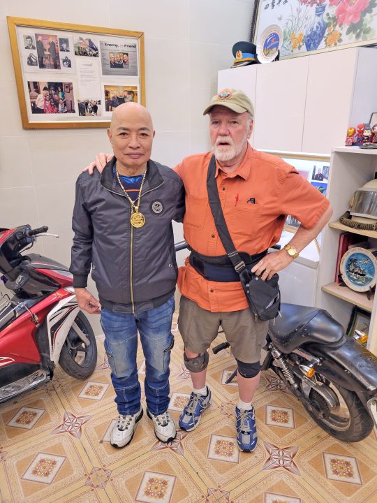 Michael Brewer with Col. My, a former NVA MiG pilot, in Vietnam on Brewer’s return to the country.