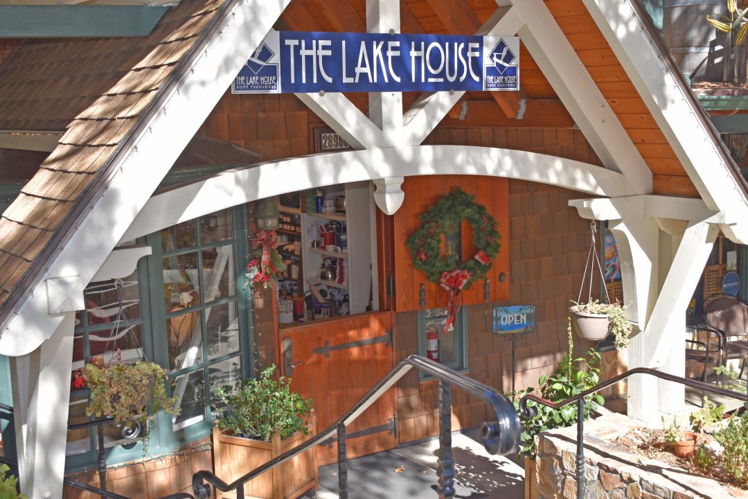 Cozy store entrance with wreath and open sign.