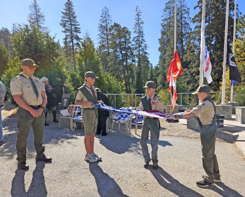 Boy Scouts Alex Heinz, Arthur Cortopassi and Wyatt DeBruyn folded a retired American flag under the watchful eye of their Scoutmaster, Charles DeBruyn.
