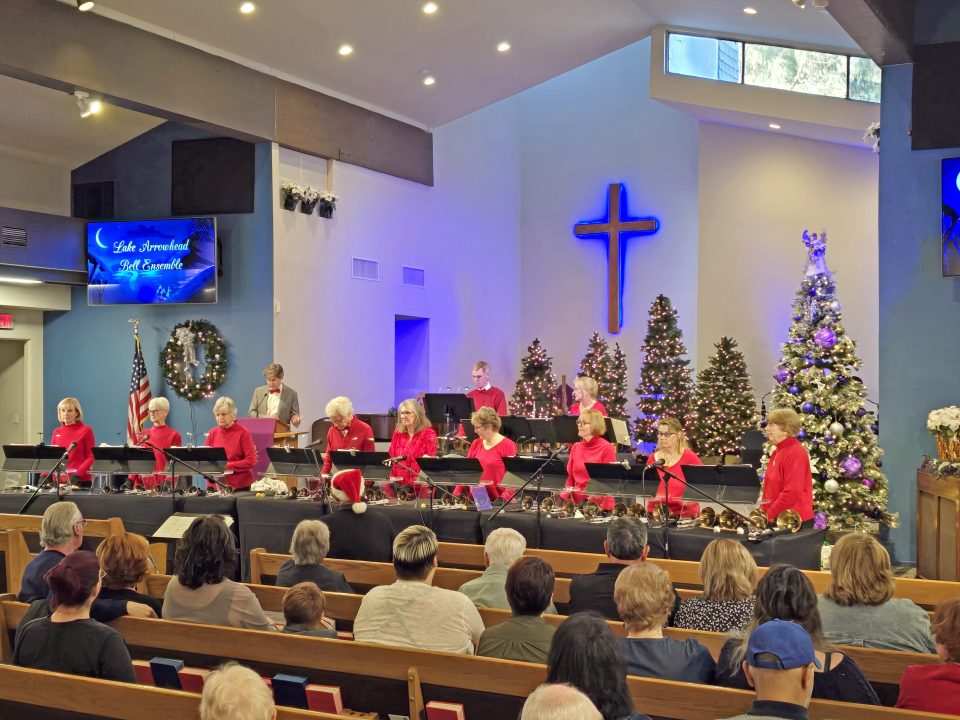 Handbell choir performing at a festive church service.