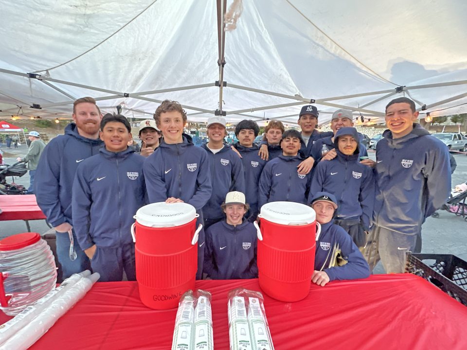 Members of this year’s Rim of the World High School varsity basketball team were on hand to help serve hot cocoa and hot dogs throughout the night at Goodwin’s Family Christmas celebration. (Photo courtesy Jessica Johnstone)