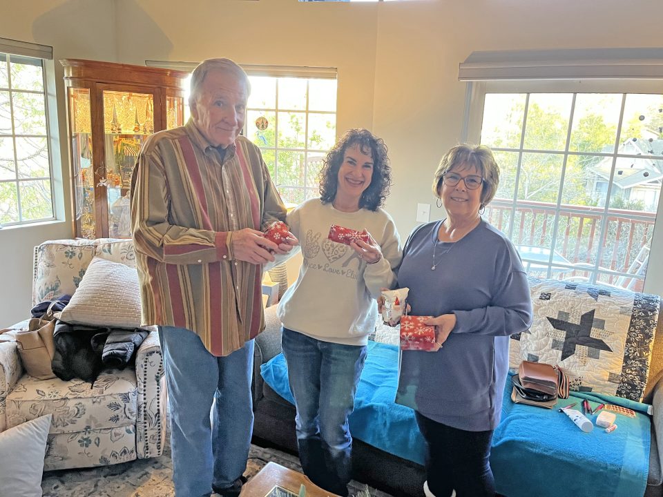 Rotarians Terry Ebert, Ronda Rynda and Teri Ostlie with some of the gifts for the homeless students.
