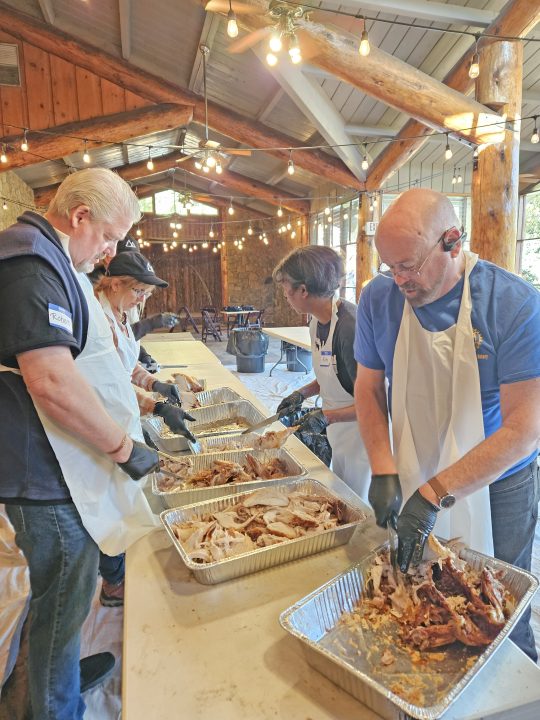Volunteers carved and broke down the final turkeys that had been prepared for the dinner at the San Moritz Lodge. (Photo by Mary-Justine Lanyon)