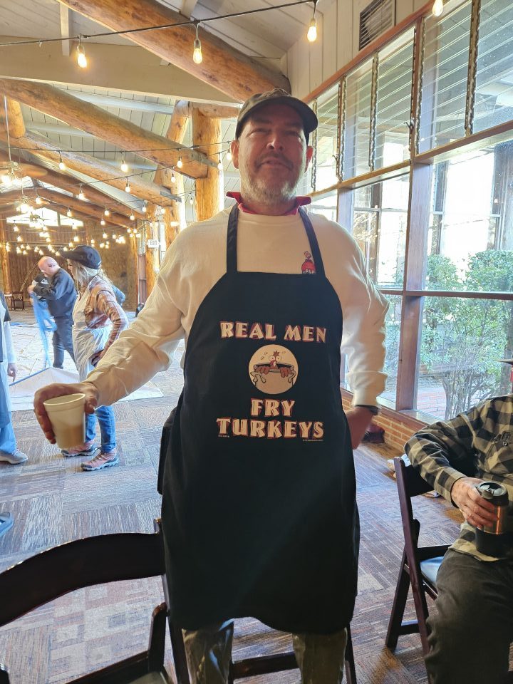 Steve’s wife got him this apron to express his love of frying the Thanksgiving turkeys. (Photo by Mary-Justine Lanyon)