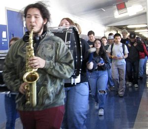 The band led the seniors, wielding blue clappers, through Rim High’s halls.