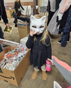 Three-year-old Charlie loved the cat mask she found. She also got a pink water bottle.