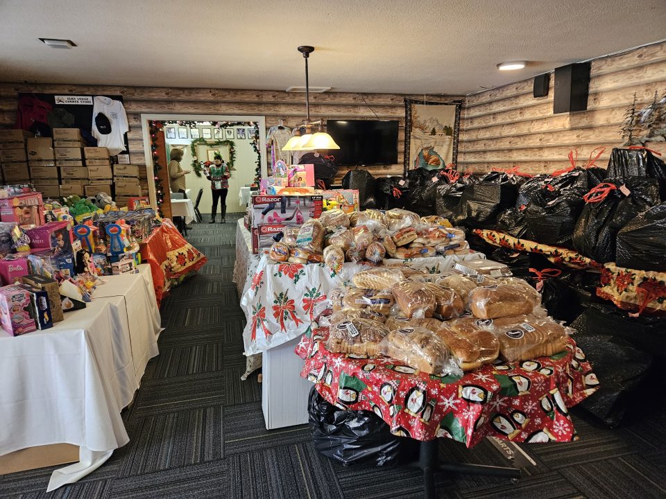 Room filled with toys and packaged bread for donation.