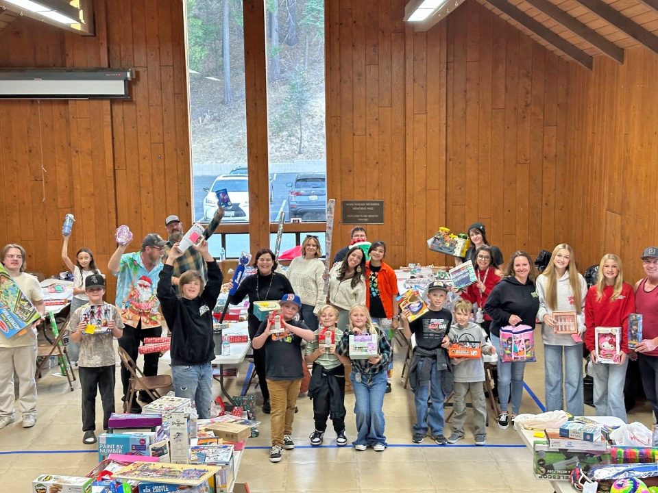Group holding toys in a community center.