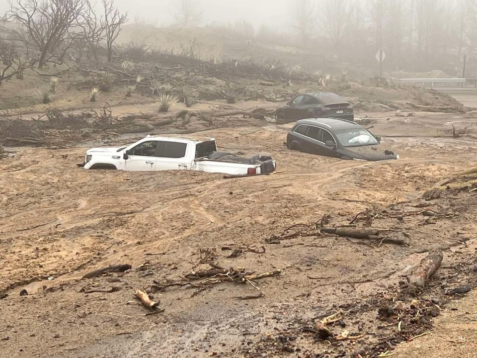 Cars stuck in a mudslide during flood.