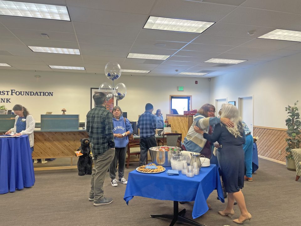 People socializing at an event with refreshments.